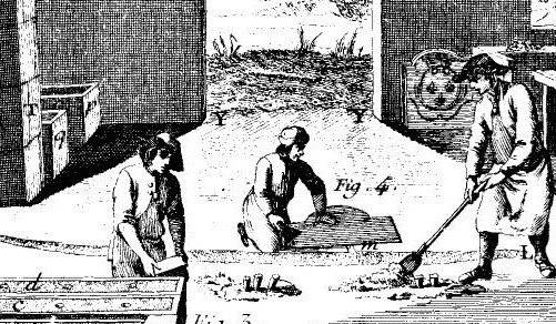 Iron workers dig a trench and press wooden forms into the sand floor