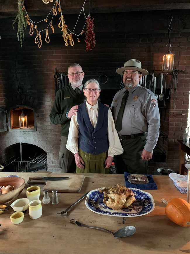 lt= Director Sams visits with Park Ranger Scott Irvine and Volunteer-in-Parks Nancy Funk at the Fort Vancouver Kitchen in March of 2022.