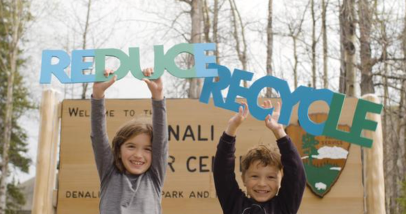 Children holding signs outdoors to support #DontFeedTheLandfills Initiative