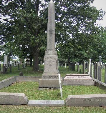 Duncombeobelisk Tall granite obelisk in a cemetery, surrounded by other gravestones, green grass visible
