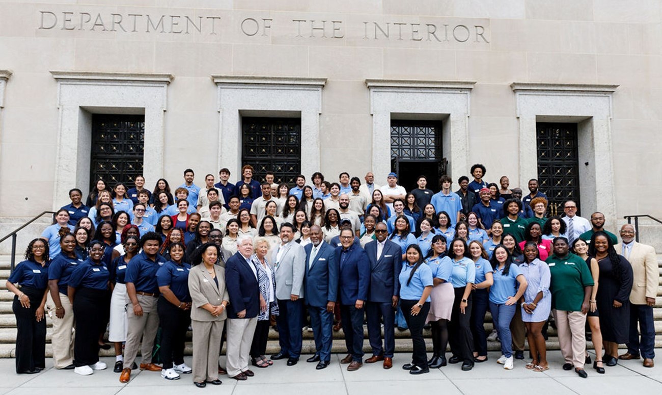 EFTA and HBCUI interns with Director Sams, NPS staff, and partners A group of individuals standing outside of a gray building