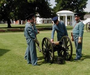 Re-enactor's prepare to fire a howitzer.