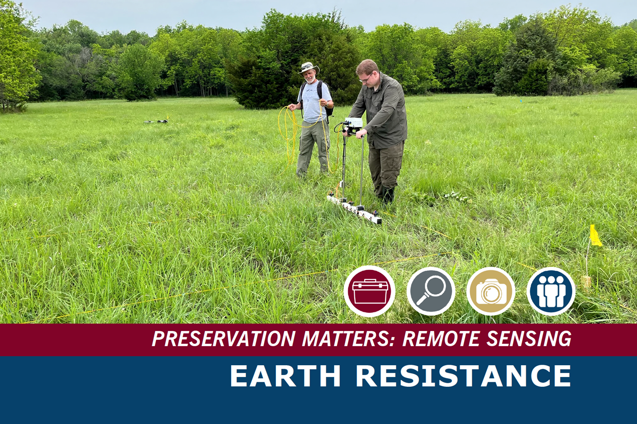 Two people take measurements in a grassy field.