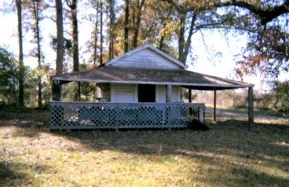 A small shed roof building with outdoor covered mercantile stand.