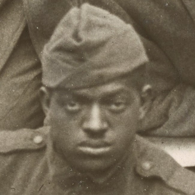 African American Soldier wearing World War One uniform looking at the camera