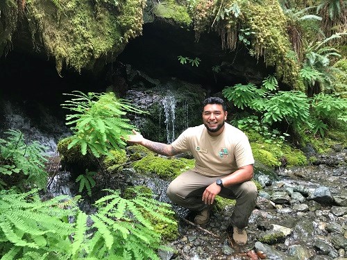 Edwin crunching and posing surrounding by plants