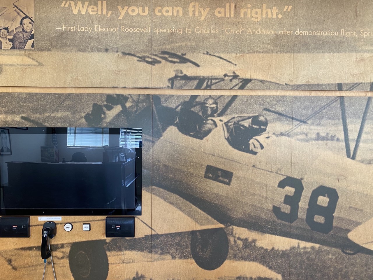 Picture and quotation from Eleanor Roosevelt’s visit, as part of a display at The Tuskegee Airmen National Historic Site Picture and quotation from Eleanor Roosevelt’s visit. "Well, you can fly alright" is written and shown with an airplane
