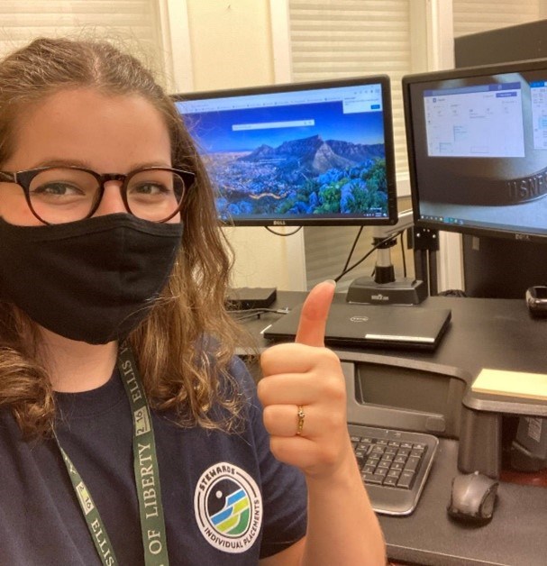 Woman giving a thumbs up at the office