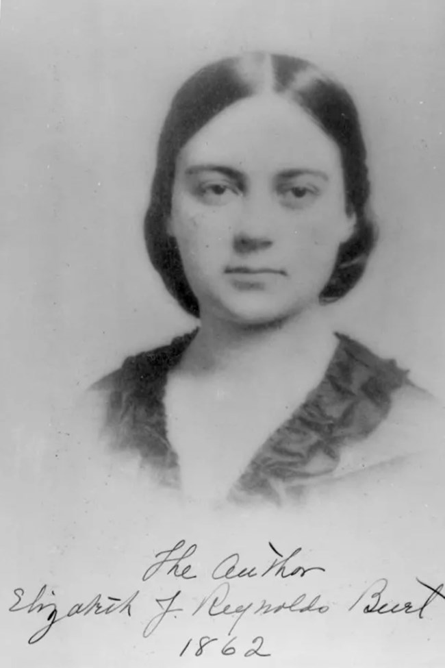 Elizabeth Burt A vintage black and white photograph of a woman, capturing her expression and style from an earlier time.