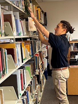 NYC Intern Emilio Gonzalez Shelving Books