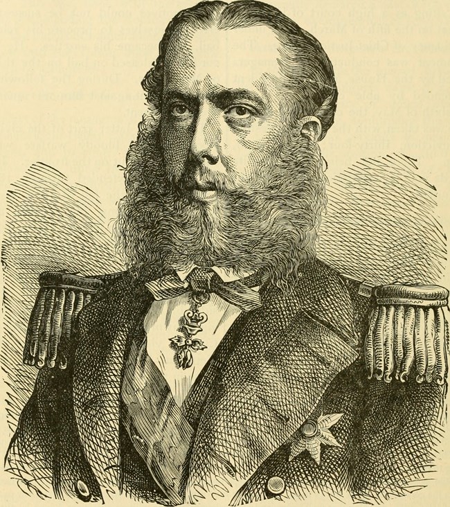 man with beard posing for an image in his military uniform.