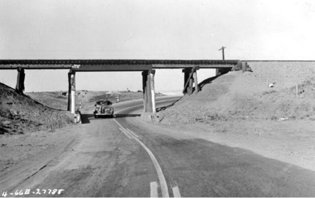 Black and white image of a highway.