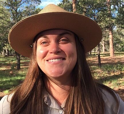 Photo of the presenter wearing a National Park Service Uniform in the outdoors.