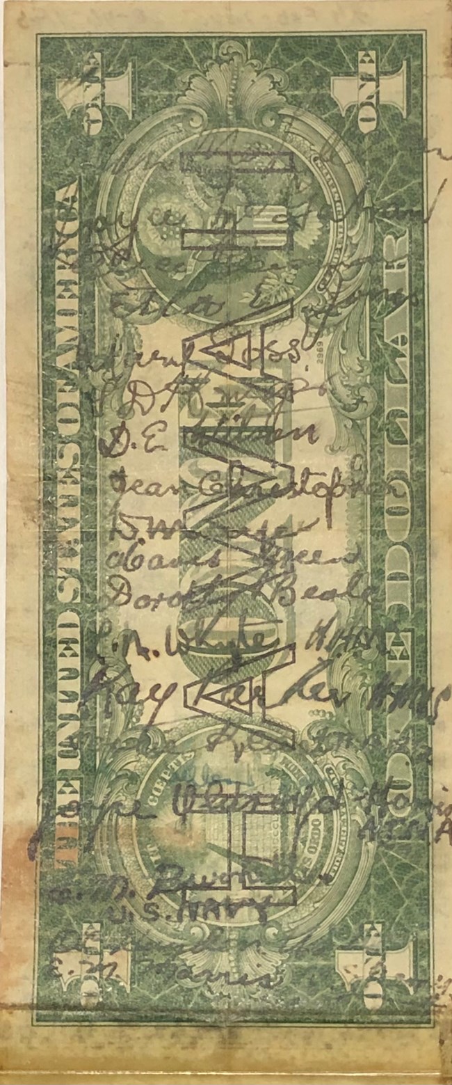 dollar bill with autographs on it
