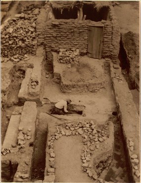 sepia-toned photo of open excavation site with brick walls
