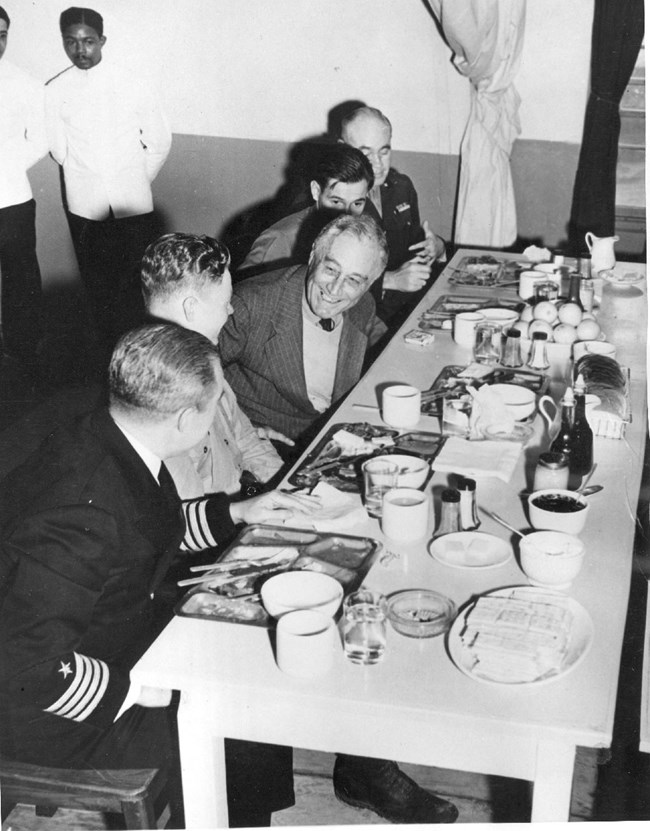 Men sitting at a table with the President.
