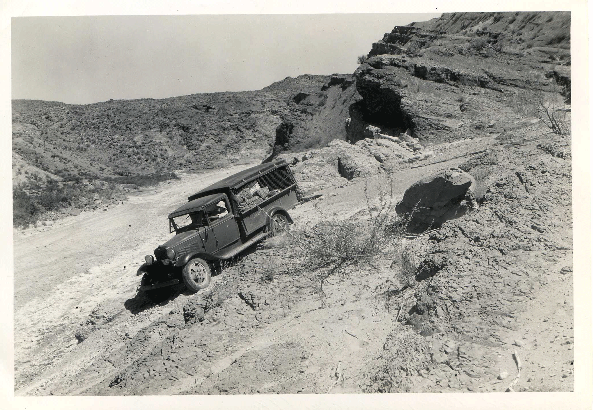 FIG 2 - vpl205 Photo of a truck driving through the desert on a dirt road.