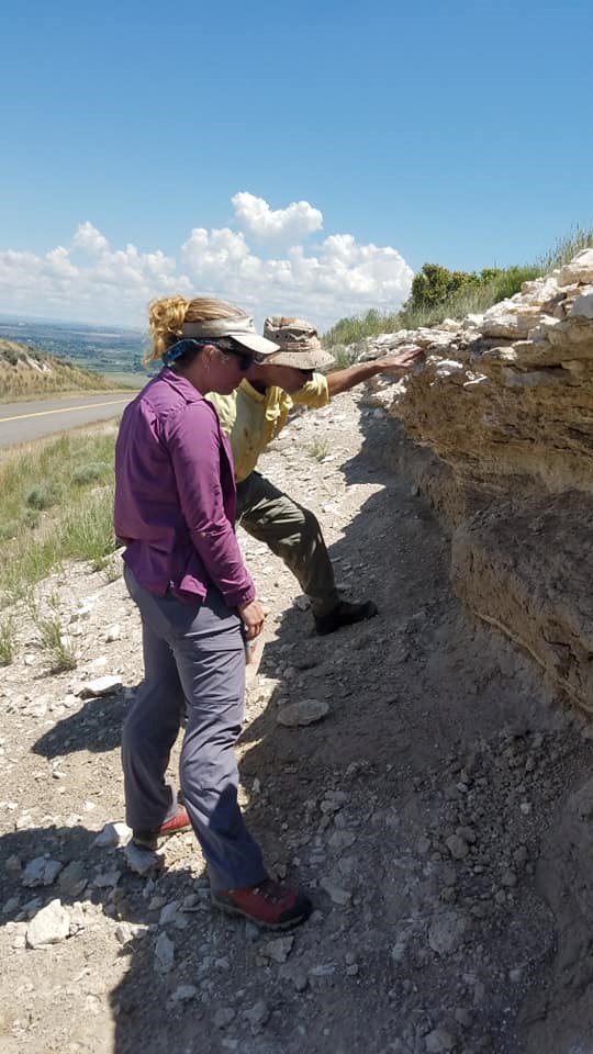 photo of two people examining a rock exposure
