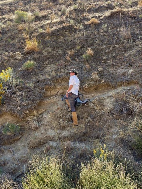 photo of a person standing on a steep hillslope