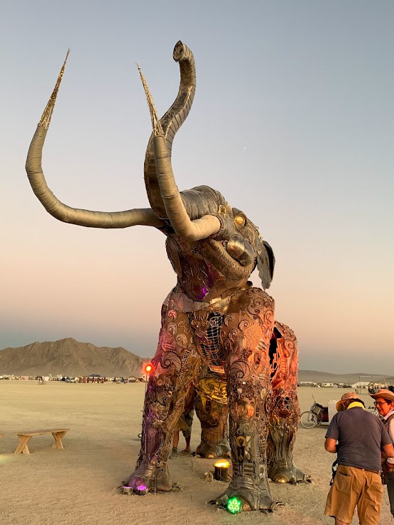 sculpture of a mammoth on a desert playa