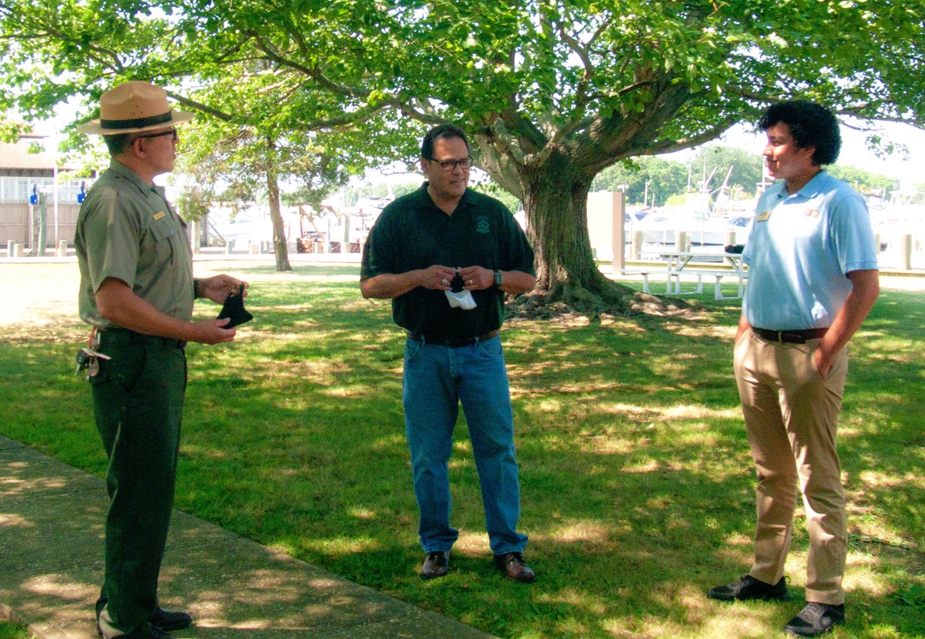 Alex Romero, David Vela, and Jhulian Gutierrez talking while socially distanced