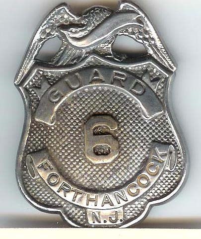 a metal ,ilitary police badge reading guard. Fort Hancock. NJ.