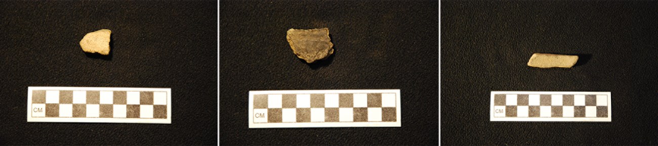 Three ceramics fragments with rulers to measure. Each fragment is between two and four centimeters wide.