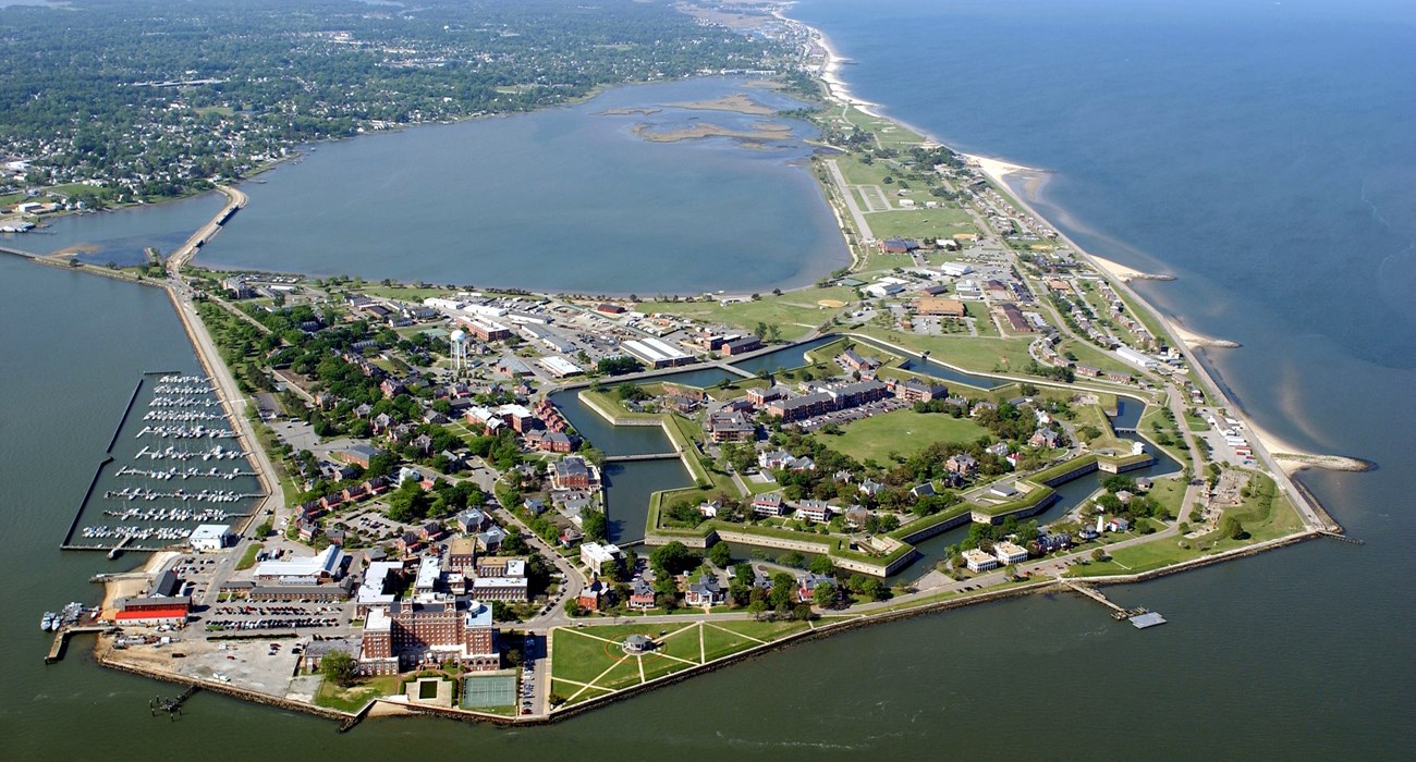 Arial view of a five-point fort surrounded by a moat and residential area