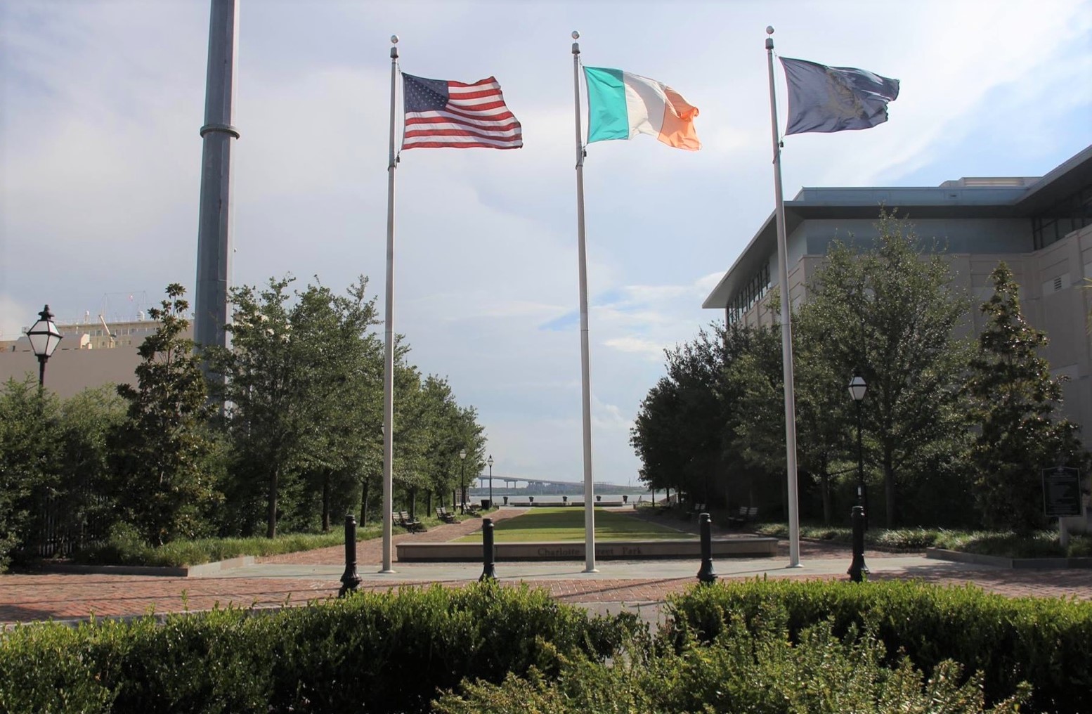 Three flags on poles outside, including for the U.S. and Ireland