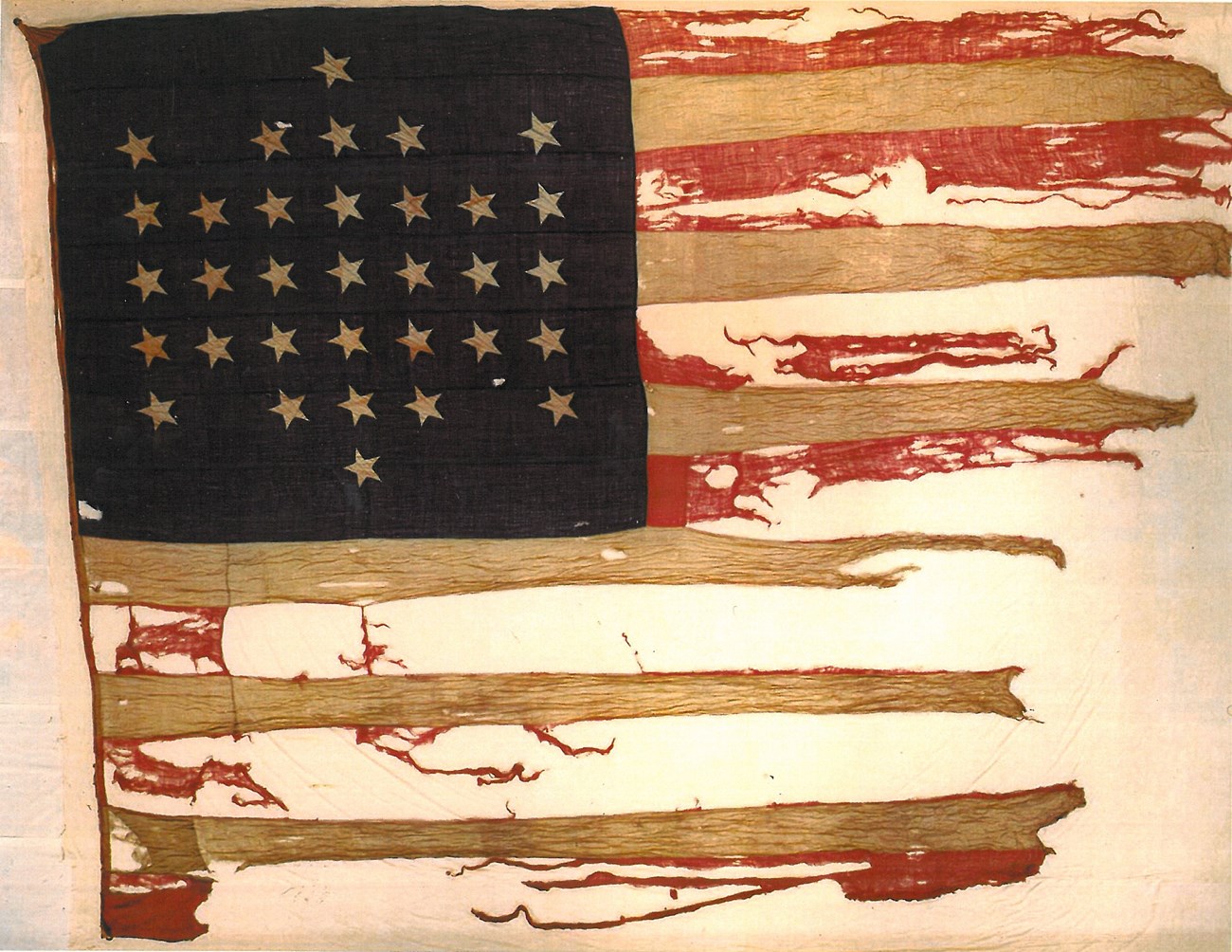 FOSU garrison flag A tattered United States flag bearing 33 stars.