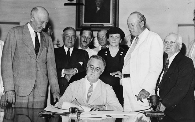 Frances Perkins (third from left) during the presidential signing of the Social Security Act (1935)