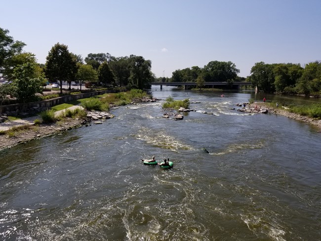Fabulous Fox! Water Trail Two people in inner tubes float gently down a wide river.