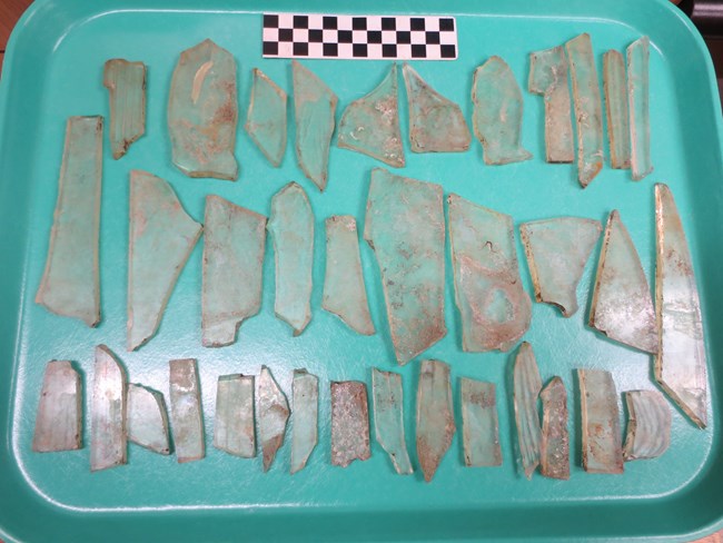 Historic glass artifact laid out on tray