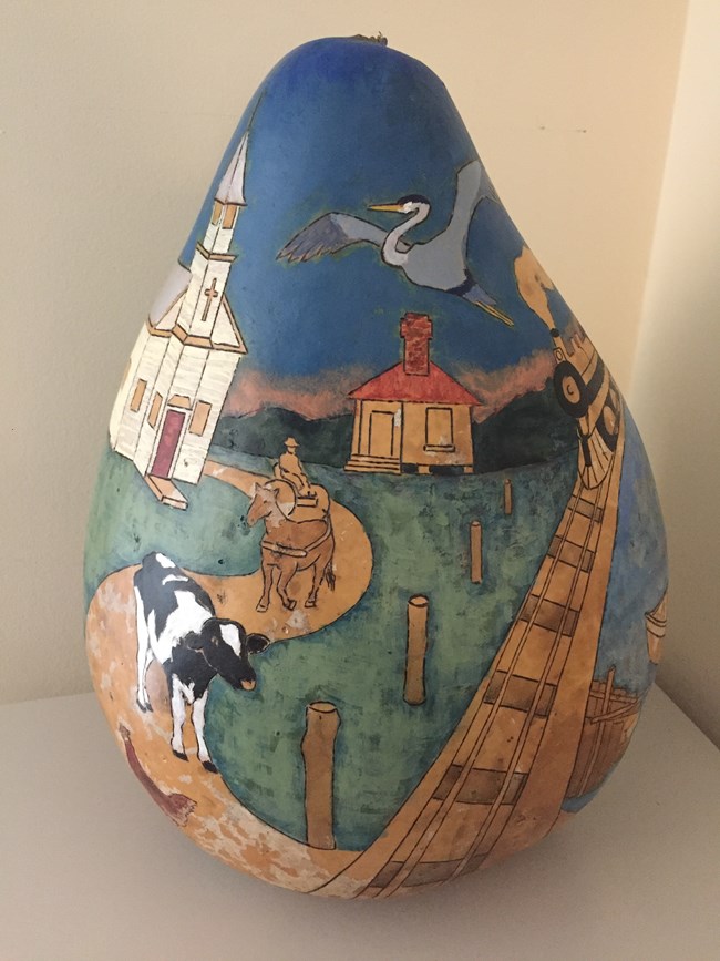 Gourd art showing a farm and a church