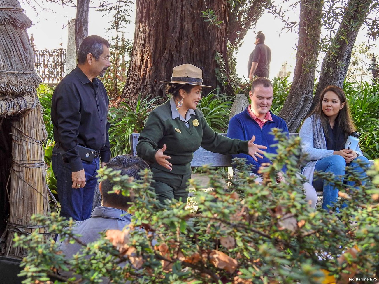 Fatima Colindres giving a talk National Park Service ranger speaking to a small group of park visitors.