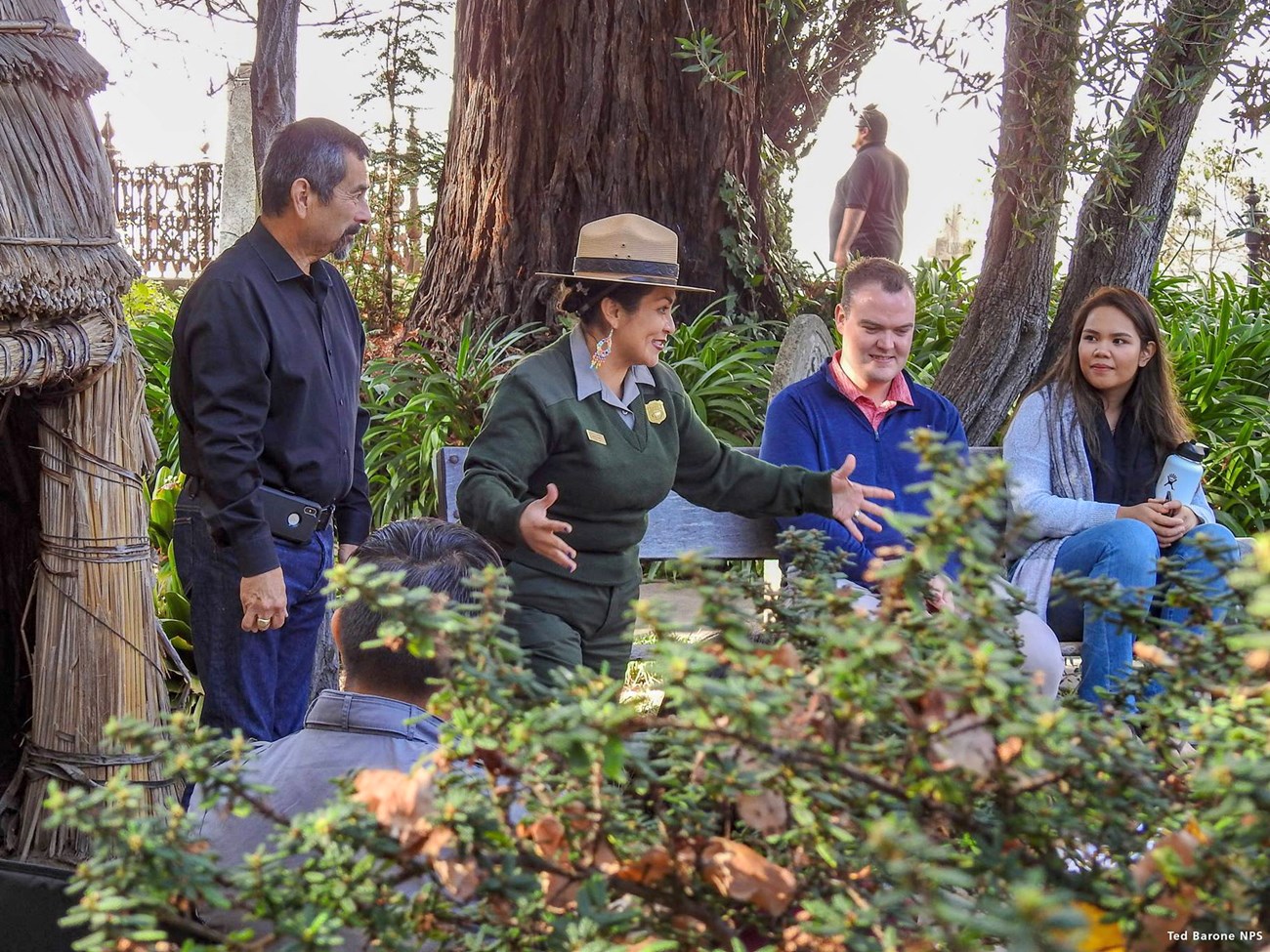 National Park Service ranger speaking to a small group of park visitors.