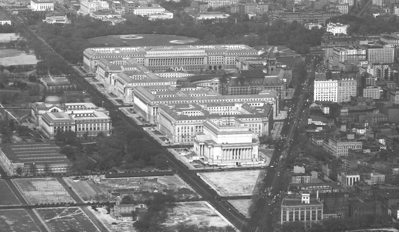 FederalTriangle_aerial A black and white aerial photo of the federal triangle after it was constructed. The point of the triangle is in the foreground, showing the National Archives building in full.