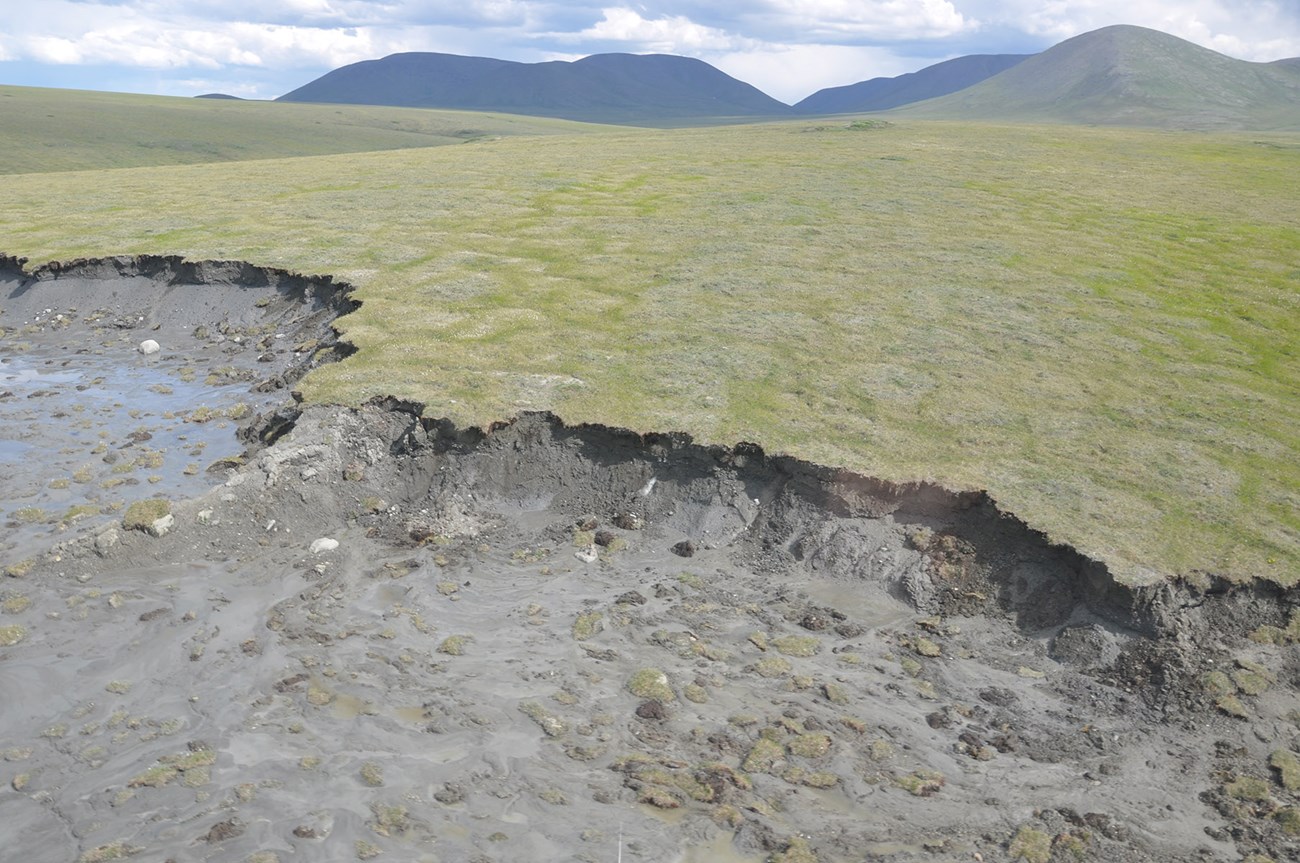 An aerial view of massive land slump in the Arctic.