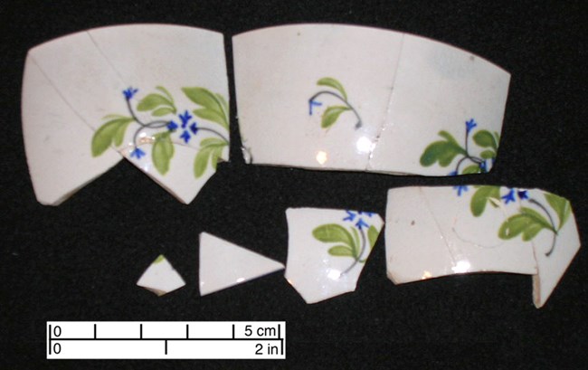 pearlware cup pieces of a hand painted pearlware cup with blue and green polychrome floral design