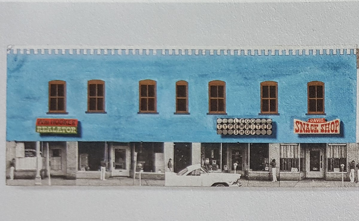 Drawing of store front painted pastel blue with brown window trim.