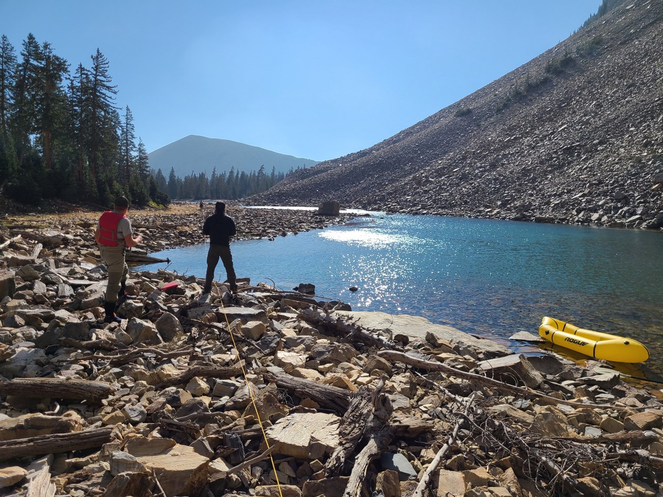 Staff performing bathymetry surveys to make calculations for the rotenone treatment.