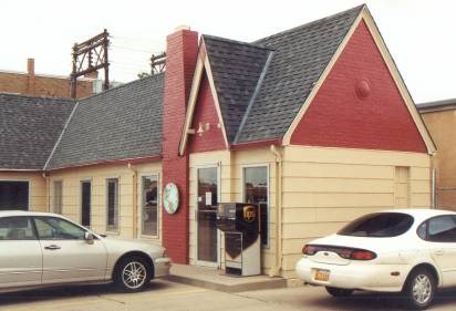 Building with yellow siding and gray roof.