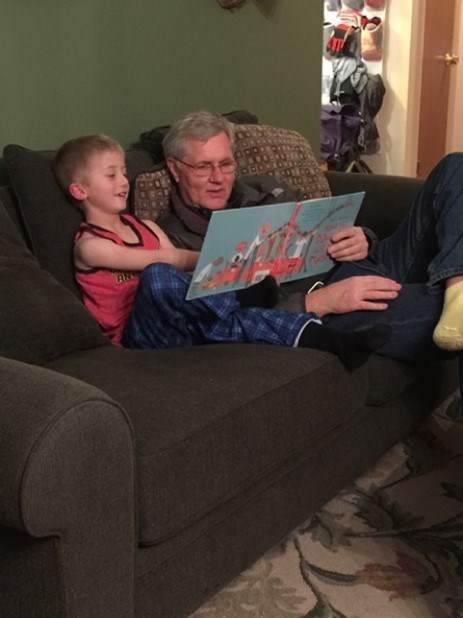 an adult reading a book to a child