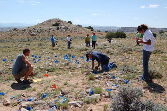 Northwest College archaeology students surveying tipi rings