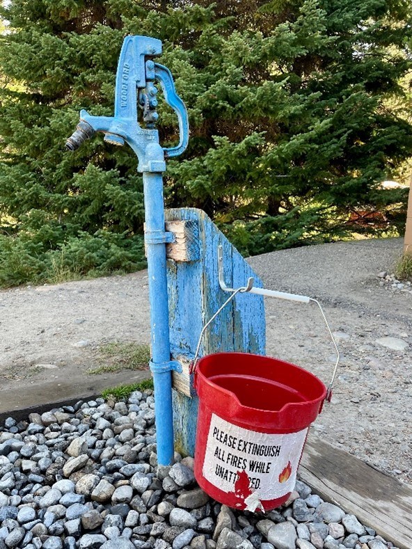 bucket hanging from a water spigot