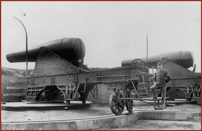 Soldier poses with canon on Alcatraz in 1896