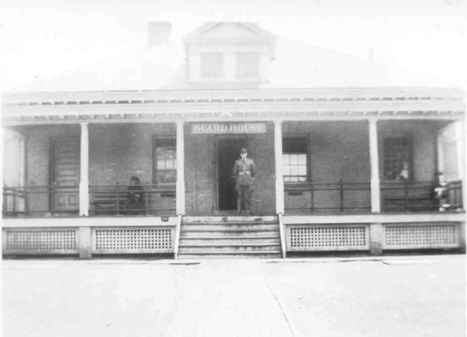 a soldier in uniform stands on the porch of a historic building