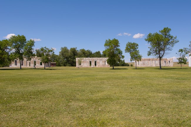 lt= A green lawn stretches back to a distant historic fort.