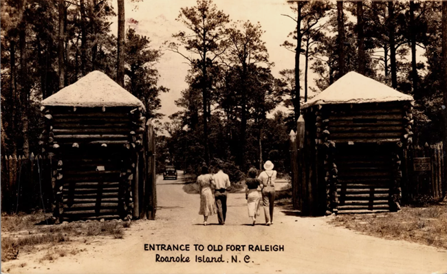 Fort Raleigh entrance ca. 1939 people walk past log cabin gate houses