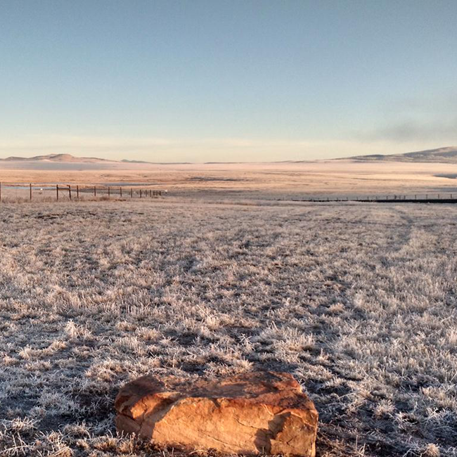 Fort Union National Monument A vast grassland valley is covered in frost in the early morning.
